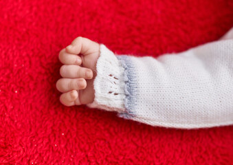 Adorable caucasian baby lying on floor over isolated red background