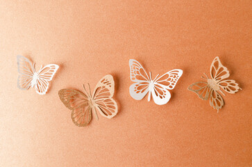 Fototapeta na wymiar The Paper butterflies on a orange paper background.