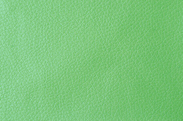 Fototapeta premium The texture of green leather with shadow as background.