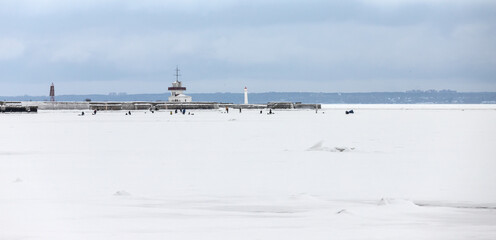 Panoramic winter landscape, fishermen are on ice