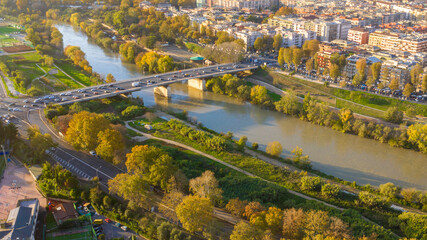 Aerial view over the Tiber River near Marconi district in Rome, Italy. Autumn colors dye the trees along the river.