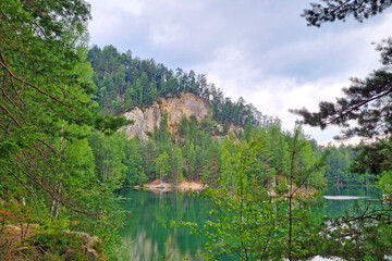 A picturesque mountain lake in the mountains. Green forest.