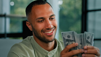 Male portrait happy smiling rich success Latin man counting money African American businessman holding fan of dollars banknotes cash financial winning prize enjoy exchange savings salary finance bribe