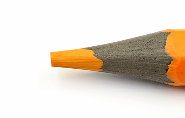 The tip of a pastel orange paint or pencil, at high magnification