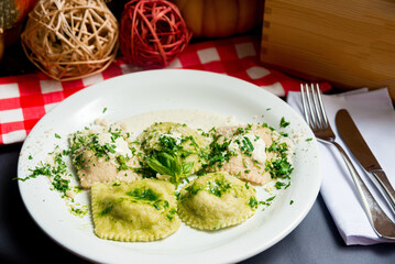 Creamy ravioli with grated cheese, cream sauce and fresh basil