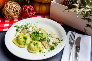 Creamy ravioli with grated cheese, cream sauce and fresh basil