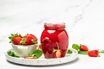 Jar of strawberry jam on white background. Homemade strawberry marmelade and fruits. Long banner format - obrazy, fototapety, plakaty
