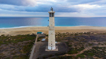 Aerial view of the Morro Jable lighthouse, built on marshland between the resort town and the Matorral Beach on the Jandia Peninsula of Fuerteventura in the Canary Islands, Spain