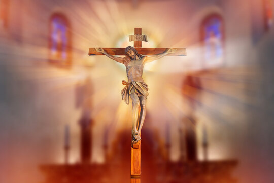 crucifix, jesus on the cross in church with ray of light from stained glass