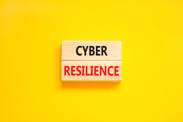 Cyber resilience symbol. Concept word Cyber resilience typed on wooden blocks. Beautiful yellow table yellow background. Business and cyber resilience concept. Copy space.