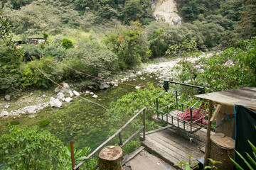 Oroya to cross the river. Hiking from Santa Teresa Hidroeléctrica to Aguas Calientes to reach Machupichu. Path following the train tracks with several hikers.