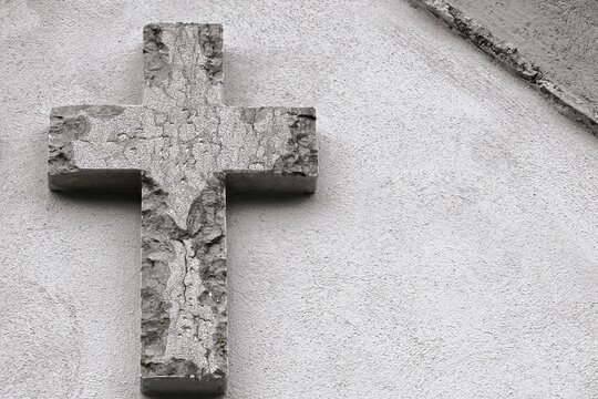 Black and white Christian cross in stone with space for text.  Christian symbol, religious faith symbolism