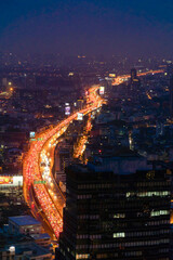 Obraz premium Aerial view of busy cars with traffic jam in the rush hour on highway road street on bridge in Bangkok Downtown, urban city in Asia, Thailand at sunset. Intersection junction. Toll gate in Rama 9