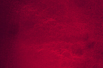 Dark purple matte background of suede fabric, closeup. Velvet texture of seamless wine leather. Felt material macro with vignette.