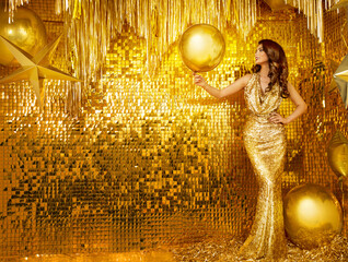 Woman in Golden Sequin Party Dress. Fashion Model in Evening Long Gown over Gold Glitter Wall...