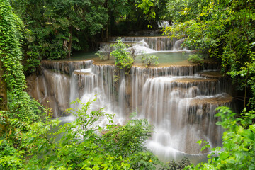 Fototapeta na wymiar Erawan Waterfall. Nature landscape of Kanchanaburi district in natural area. it is located in Thailand for travel trip on holiday and vacation background, tourist attraction.