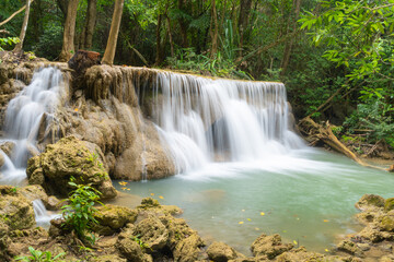 Fototapeta na wymiar Erawan Waterfall. Nature landscape of Kanchanaburi district in natural area. it is located in Thailand for travel trip on holiday and vacation background, tourist attraction.