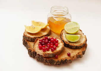 Honey, lemon and lime on a white background, on a creative designer stand. Proper nutrition.