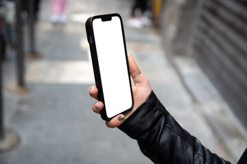 The girl's hand is holding a phone. Phone mockup in hand