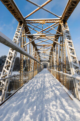 sunny winter landscape with iron construction bridge, Valmiera