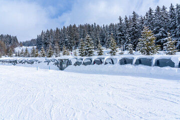 Magicagic carpet ski lift in a glass tunel. Snowy winter day in the french ski resort. High quality photo