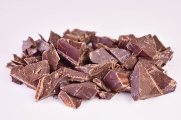 Black chocolate pieces on a white background.Close-up.	