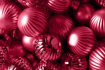 Shiny Christmas balls in viva magenta trendy color as holiday background. Xmas festive greeting...
