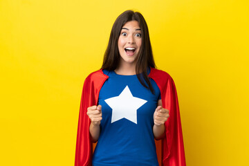 Super Hero Brazilian woman isolated on yellow background celebrating a victory in winner position