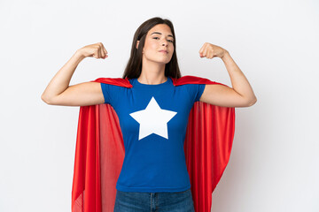Young Brazilian woman isolated on white background in superhero costume and doing strong gesture © luismolinero
