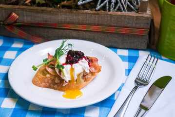 Poached egg on bruschetta with microgreens and caramelized onions