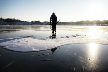 A man with a backpack travels in winter. A man in a snowy field. Hiking winter landscape.
