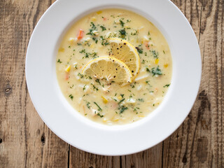 Lemon creamy soup on wooden table
