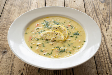 Lemon creamy soup on wooden table
