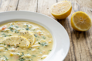 Lemon creamy soup on wooden table
