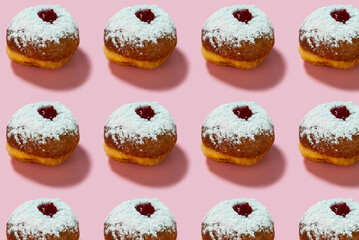 Jewish holiday Hanukkah concept. Pattern with donut sufganiyot on a pink background.