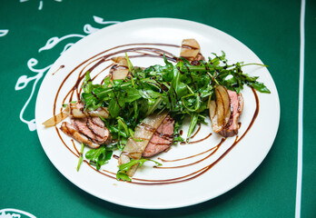 Duck fillet sous vide with fresh arugula and drunken pear