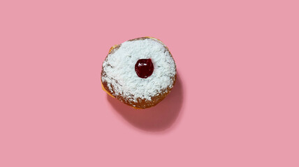 Jewish holiday Hanukkah concept. Pattern with donut sufganiyot on a pink background.