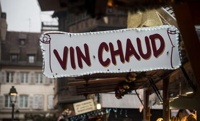 Closeup of mulled wine sign in french at the christmas market, traduction in english of vin chaud...