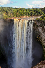Kayetur Waterfall with clouds of spray and fog on a clear sunny day in the jungle, Guyana. Subtropics, world tourism.