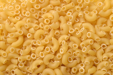 Raw uncooked pasta horns background