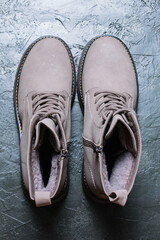 Women's winter boots with laces on a gray background. The concept of modern women's fashion