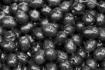 selective focus: purple olives marinated with blueberries and flavored