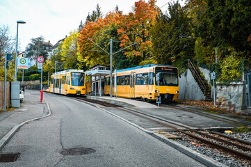Naklejka na ściany i meble Stuttgart, Germany: October 16, 2022: Two yellow cog railway cars standing at a station during autumn.