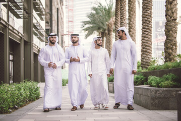 Group of arab businessmen wearing emirates kandora in Dubai - Business people meeting outoors in the UAE