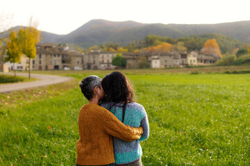 gay women couple hugging and giving affection in a Spanish rural town. Love in Valentine's