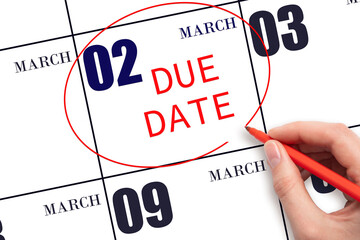 Hand writing text DUE DATE on calendar date March 2 and circling it. Payment due date