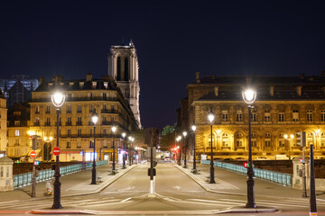 Fototapeta na wymiar Pont d'Arcole overlooking Notre Dame cathedral at night in Paris. France