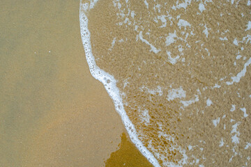 wave of salty sea water on the beach sand