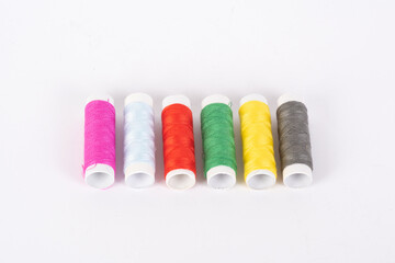 assorted spools of thread on a white background