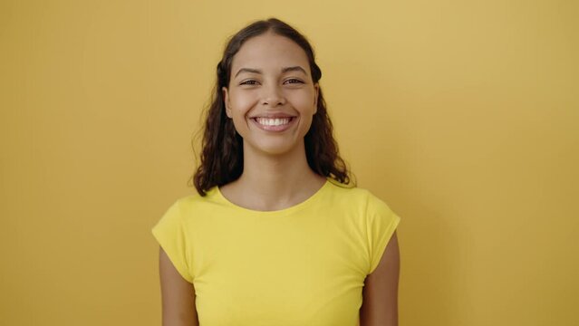 Young african american woman smiling confident standing over isolated yellow background